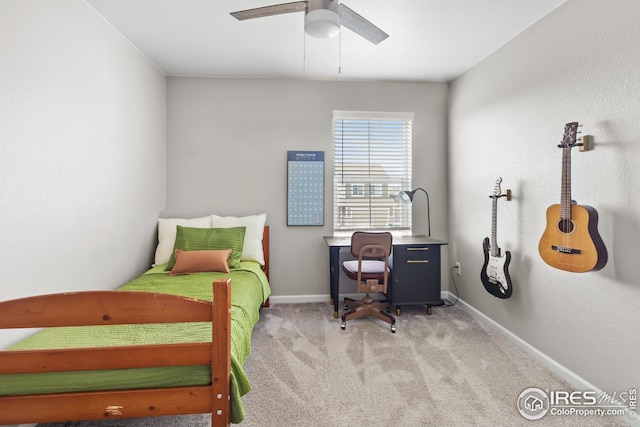 bedroom featuring light carpet, baseboards, and a ceiling fan