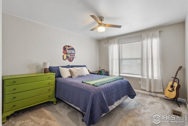 carpeted bedroom with a ceiling fan and baseboards