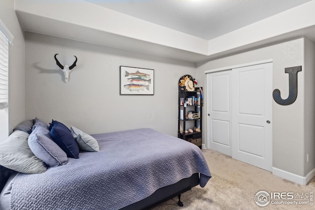 bedroom with light colored carpet and a closet