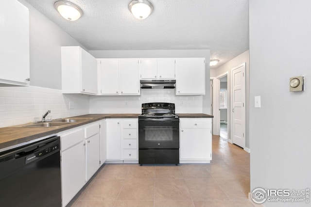 kitchen with black appliances, under cabinet range hood, a sink, and white cabinets