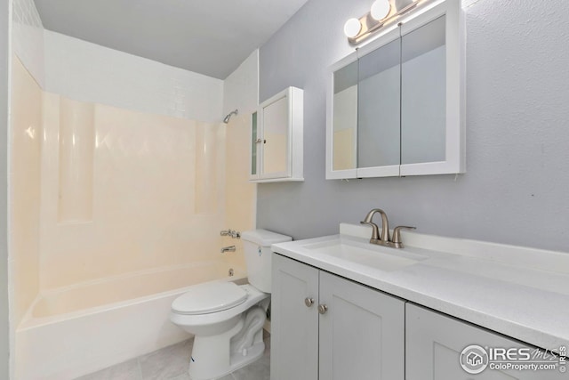 bathroom featuring tile patterned floors, toilet, vanity, and washtub / shower combination