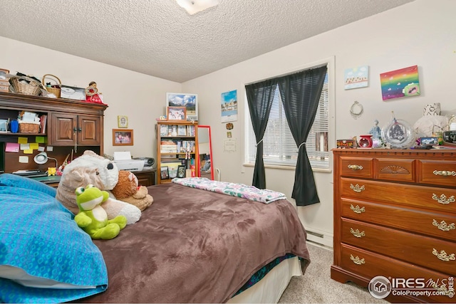 carpeted bedroom with a textured ceiling and baseboard heating