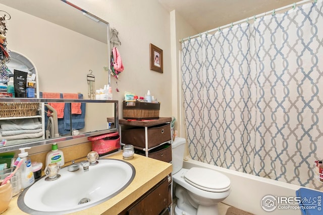 full bathroom with toilet, shower / bathtub combination with curtain, and vanity