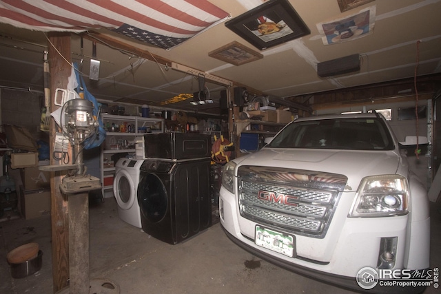 garage featuring a garage door opener and washer and dryer