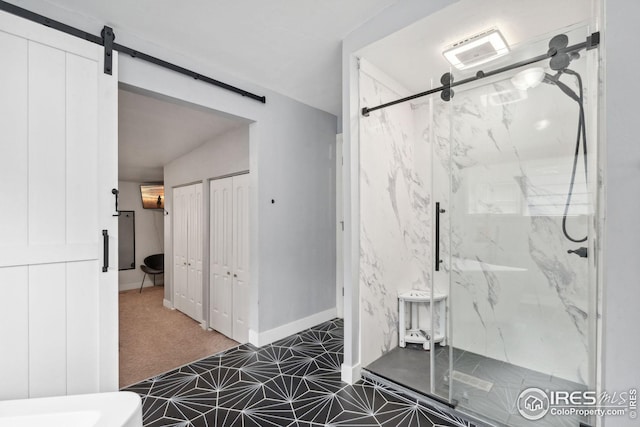 bathroom featuring baseboards and a marble finish shower