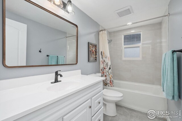 bathroom featuring tile patterned floors, vanity, shower / tub combo with curtain, toilet, and visible vents