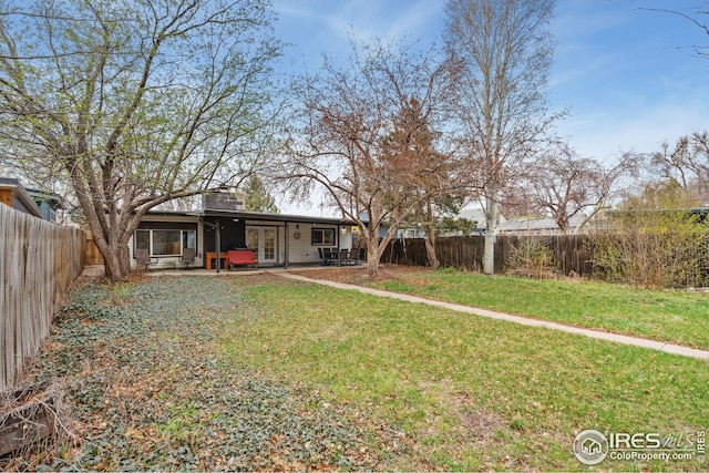 view of yard featuring a patio area and a fenced backyard