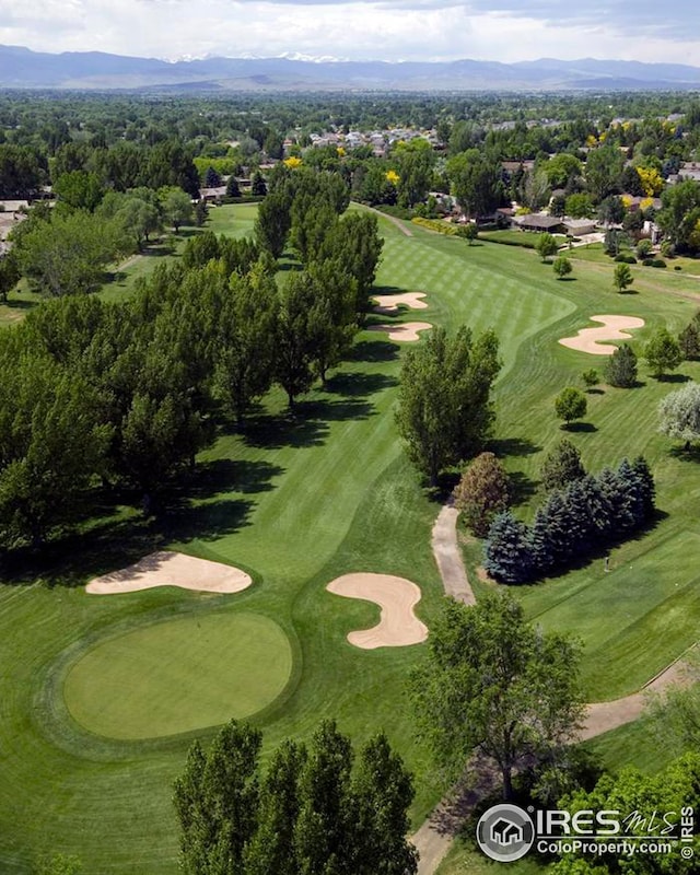birds eye view of property with a mountain view and view of golf course