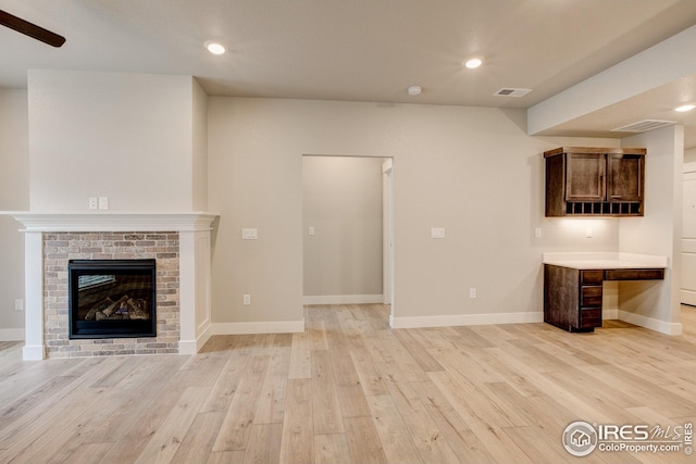 unfurnished living room featuring baseboards, light wood-type flooring, and recessed lighting
