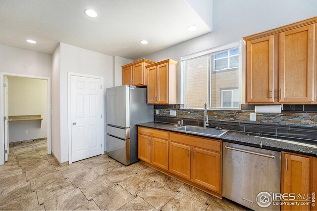 kitchen featuring a sink, recessed lighting, decorative backsplash, and appliances with stainless steel finishes