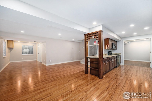 kitchen featuring dark brown cabinets, black microwave, light wood-type flooring, range with electric stovetop, and recessed lighting