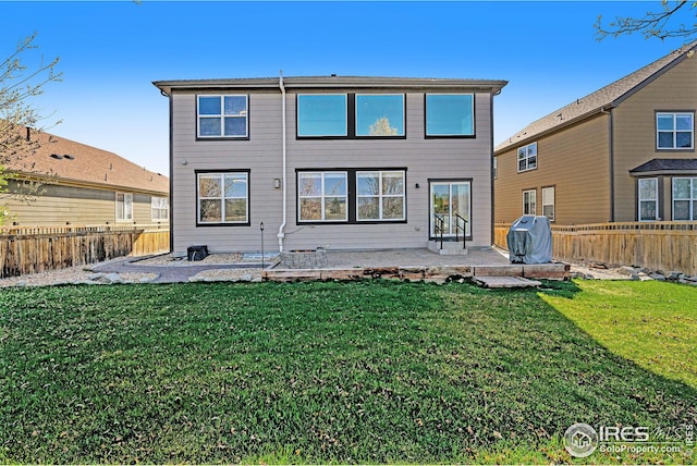 back of house featuring a patio and a lawn