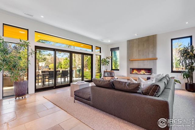 living room with recessed lighting, visible vents, a large fireplace, and french doors