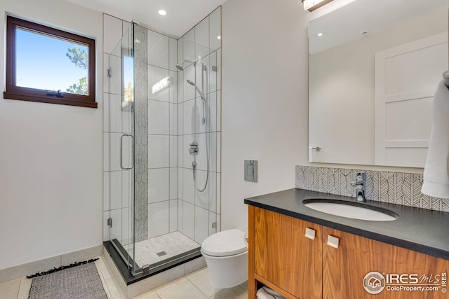 bathroom featuring toilet, recessed lighting, vanity, tile patterned flooring, and a stall shower