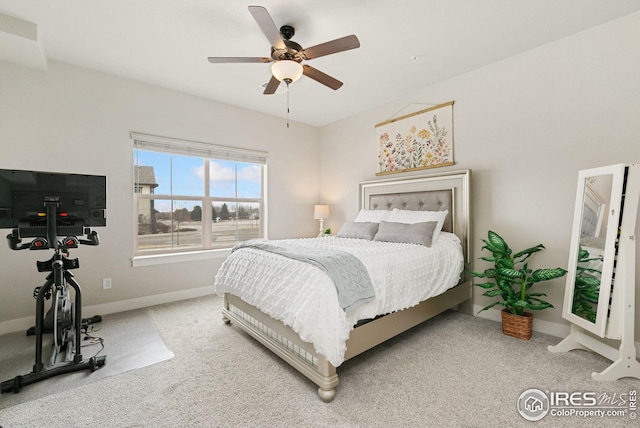 carpeted bedroom featuring baseboards, a ceiling fan, and visible vents