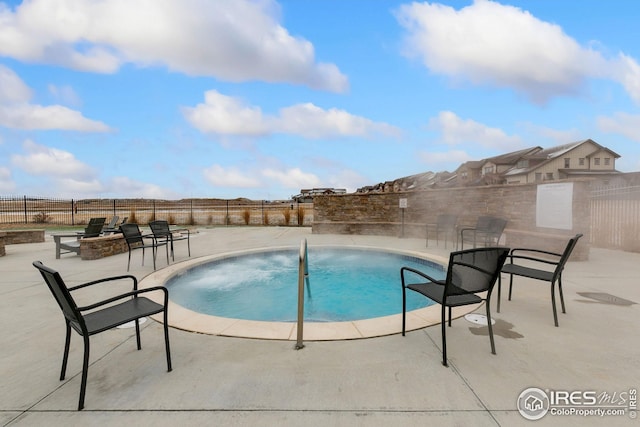 view of swimming pool featuring a fenced in pool, a patio, fence, and an outdoor fire pit