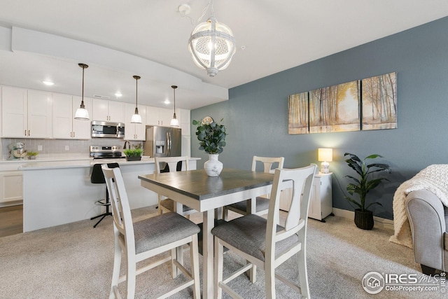 dining room with baseboards, an inviting chandelier, and carpet floors
