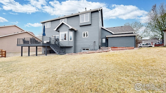 rear view of house with a yard, stairway, and a wooden deck
