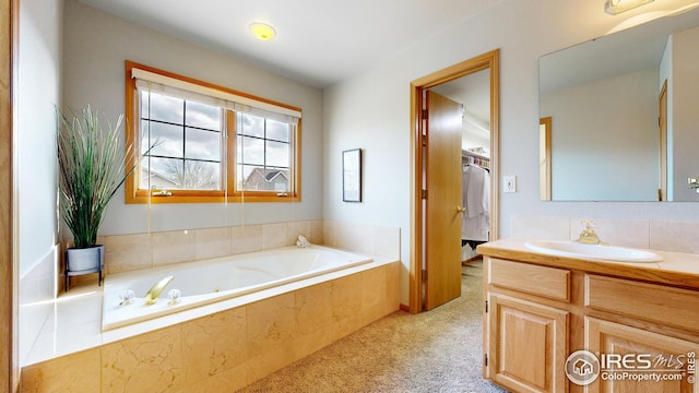 full bathroom featuring a bath and vanity