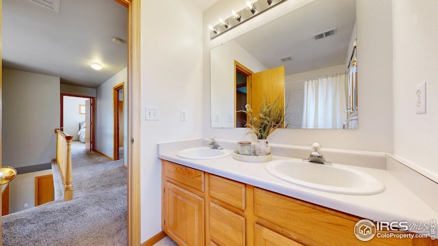 full bathroom featuring double vanity, visible vents, and a sink