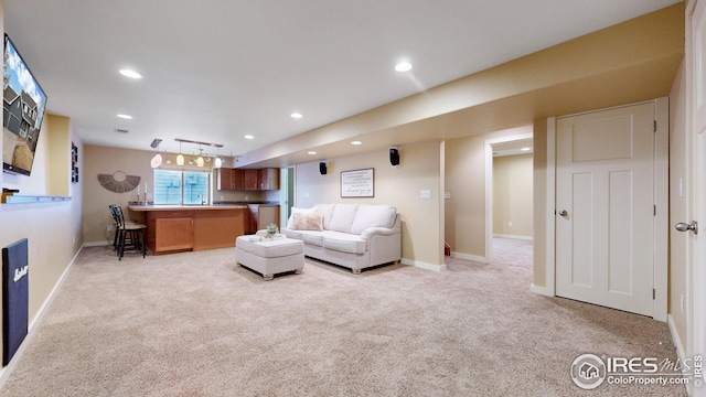 living area with baseboards, recessed lighting, and light carpet