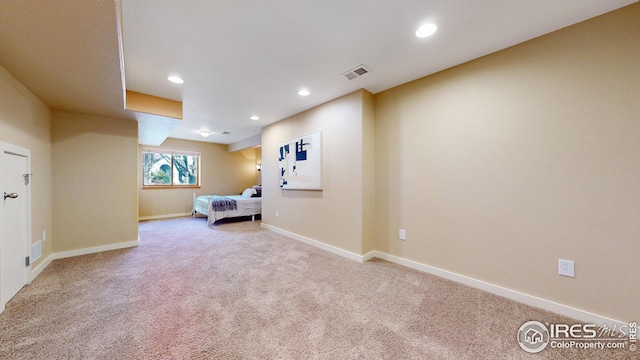 unfurnished bedroom with baseboards, carpet, visible vents, and recessed lighting