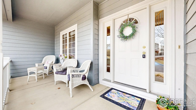 view of exterior entry with a porch