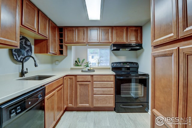 2924 Ross Dr Unit H20, Fort Collins, CO 80526 - kitchen featuring light countertops, black appliances, under cabinet range hood, brown cabinets, and a sink