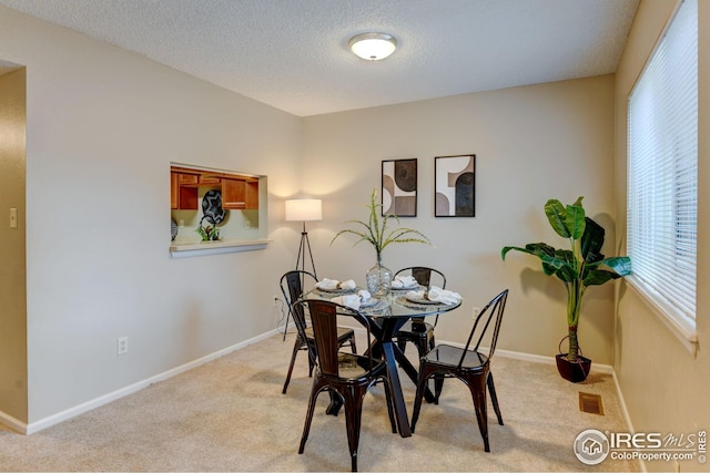 2924 Ross Dr Unit H20, Fort Collins, CO 80526 - dining area with visible vents, light colored carpet, baseboards, and a textured ceiling
