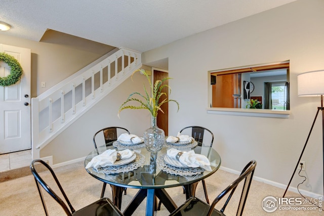 2924 Ross Dr Unit H20, Fort Collins, CO 80526 - carpeted dining space featuring a textured ceiling, baseboards, and stairs