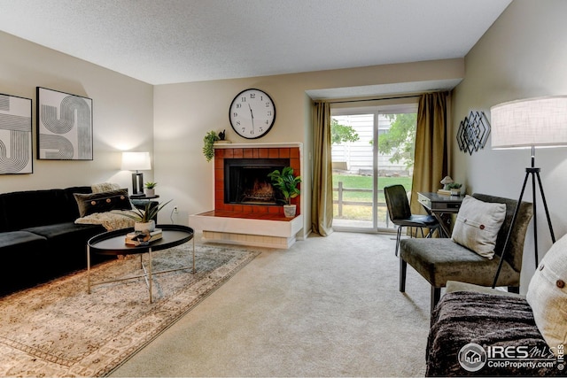 2924 Ross Dr Unit H20, Fort Collins, CO 80526 - living area with a fireplace, carpet, and a textured ceiling