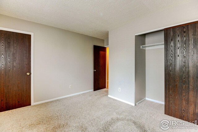 2924 Ross Dr Unit H20, Fort Collins, CO 80526 - unfurnished bedroom with a textured ceiling, baseboards, and carpet floors