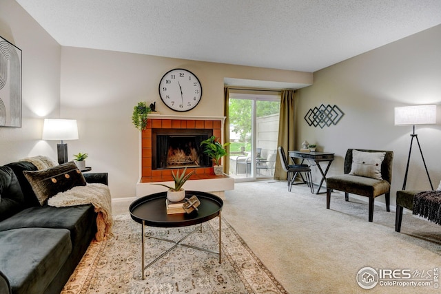 2924 Ross Dr Unit H20, Fort Collins, CO 80526 - living room with a fireplace, carpet flooring, a textured ceiling, and baseboards