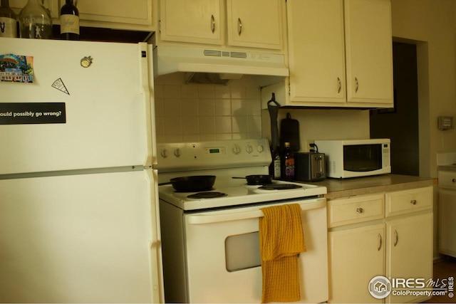 kitchen featuring decorative backsplash, white appliances, and under cabinet range hood