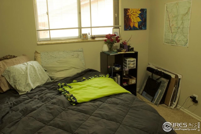 bedroom with carpet flooring and baseboards