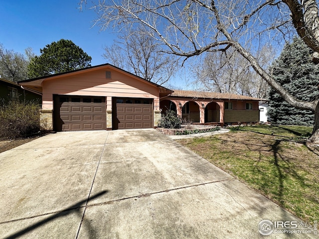 1401 Constitution Ave, Fort Collins, CO 80521 - single story home featuring brick siding, an attached garage, a front lawn, and concrete driveway