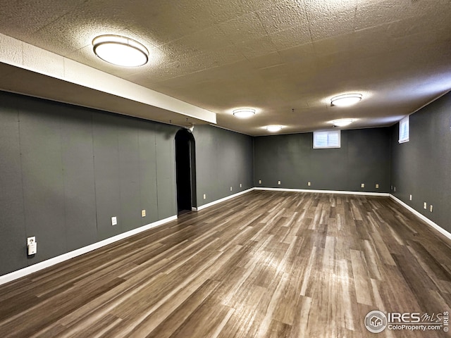 1401 Constitution Ave, Fort Collins, CO 80521 - below grade area featuring a textured ceiling, wood finished floors, and baseboards