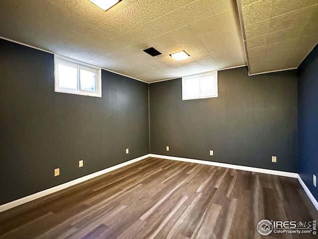 1401 Constitution Ave, Fort Collins, CO 80521 - below grade area featuring baseboards, a textured ceiling, and wood finished floors