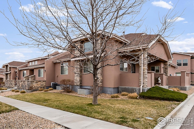 craftsman house with stucco siding, a residential view, a front lawn, and stone siding