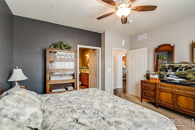 bedroom featuring carpet flooring, a textured wall, a ceiling fan, connected bathroom, and baseboards