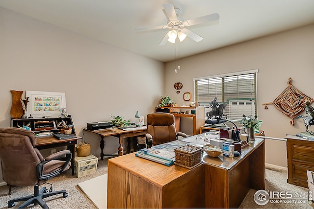 office with light colored carpet, a ceiling fan, and baseboards