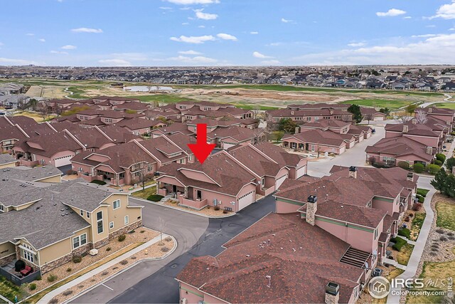 aerial overview of property's location with nearby suburban area and a golf course