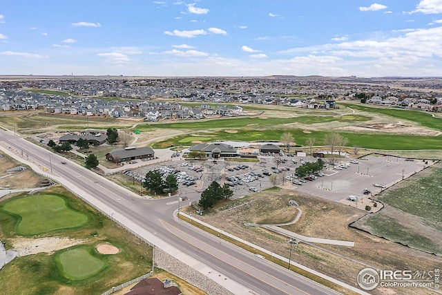 aerial view of property's location with a golf club and nearby suburban area