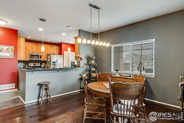 dining space featuring baseboards, dark wood-type flooring, and recessed lighting