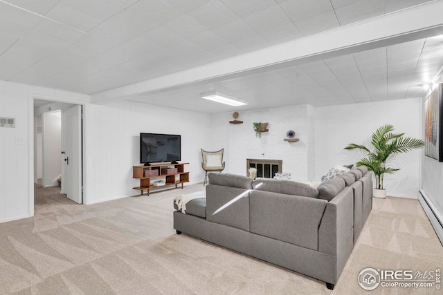 living room featuring carpet and a brick fireplace