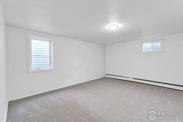 unfurnished bedroom featuring a closet, light wood-type flooring, a baseboard heating unit, and baseboards