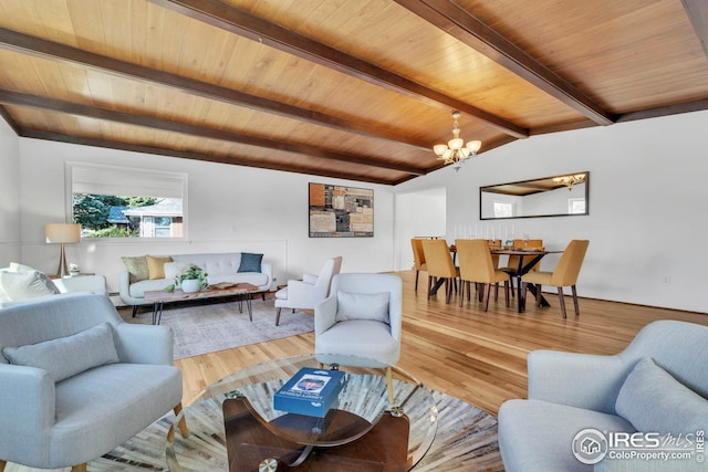 living area featuring a chandelier, lofted ceiling with beams, wooden ceiling, and wood finished floors
