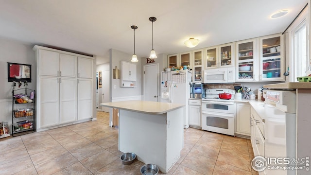 2706 Balmoral Ct, Fort Collins, CO 80525 - kitchen featuring tasteful backsplash, light countertops, glass insert cabinets, white appliances, and light tile patterned flooring