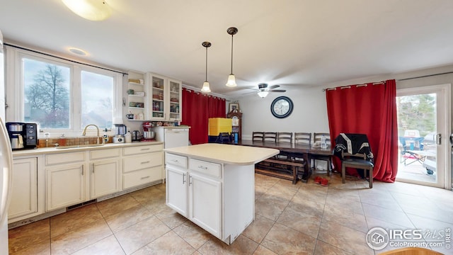 2706 Balmoral Ct, Fort Collins, CO 80525 - kitchen featuring a ceiling fan, decorative light fixtures, a sink, light countertops, and glass insert cabinets