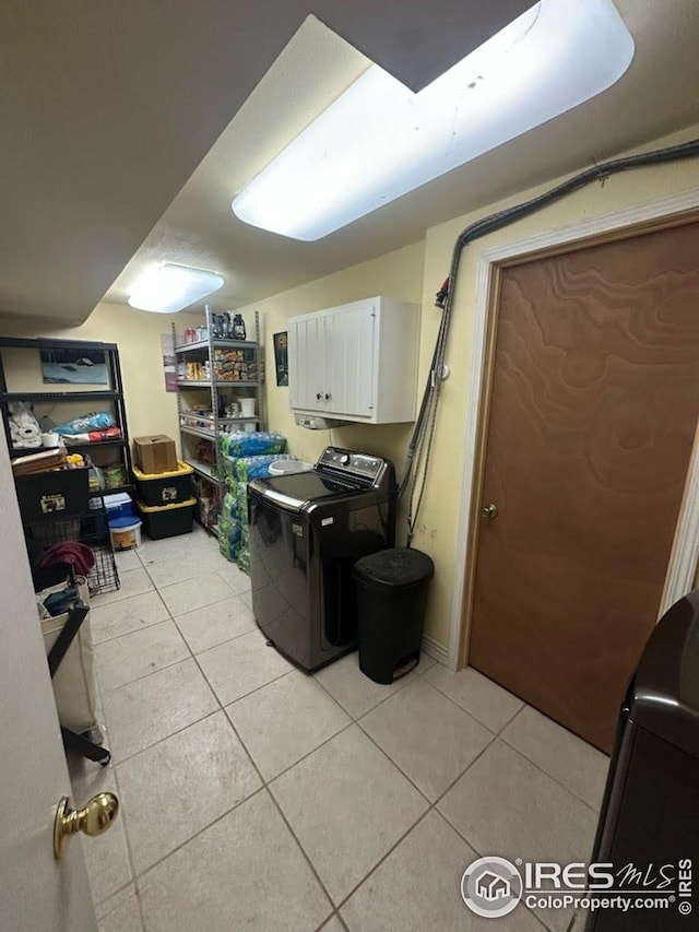 2706 Balmoral Ct, Fort Collins, CO 80525 - laundry room featuring washer and clothes dryer, cabinet space, and light tile patterned floors